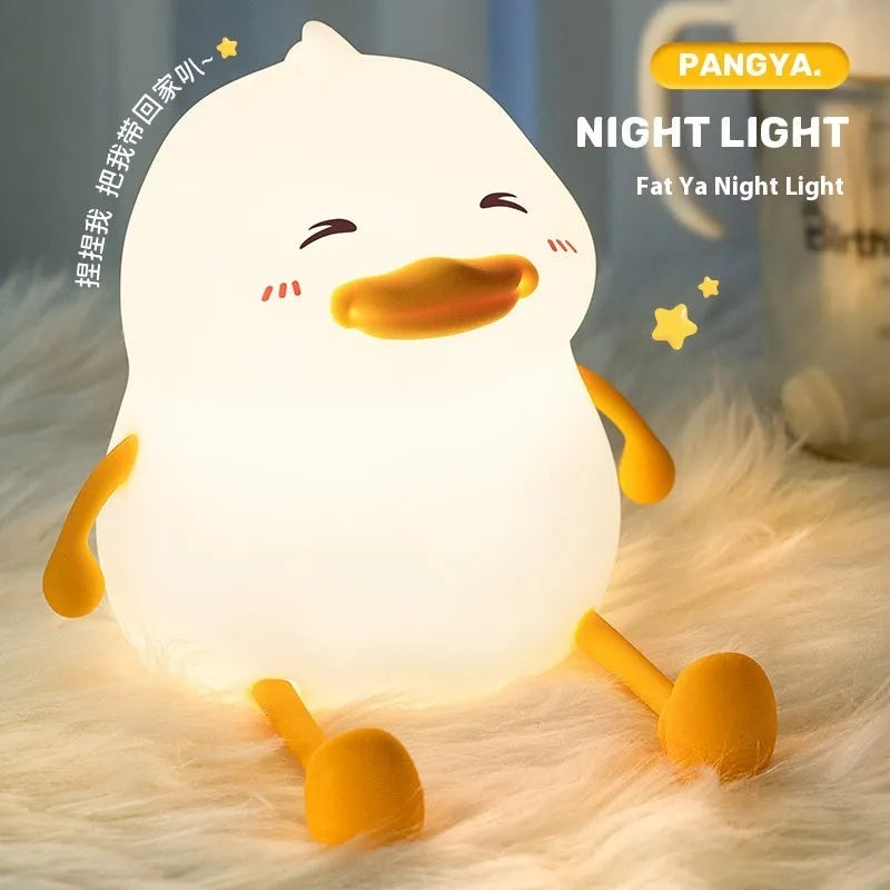 Chubby rechargeable touch-control night light with soft silicone phone holder base.