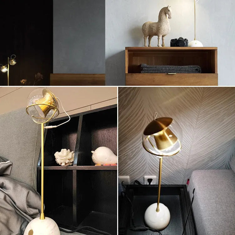Clear glass dimmable desk lamp with touch switch on a wooden desk.