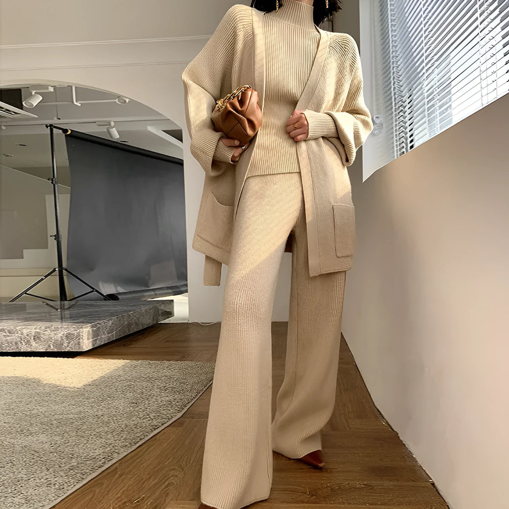 Women's apricot knitted wide-leg pants and cardigan three-piece set with leather stitching detail.