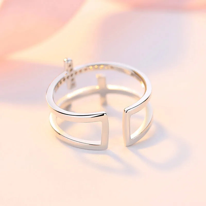 Women's adjustable copper ring with geometric double cross design and zircon stone inlay in silver setting