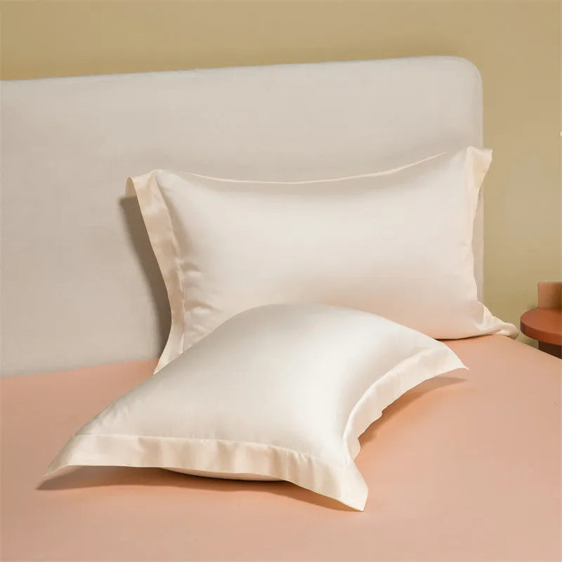 Solid colour Tencel Lyocell bed linen set with quilt cover and pillowcases on a bed.