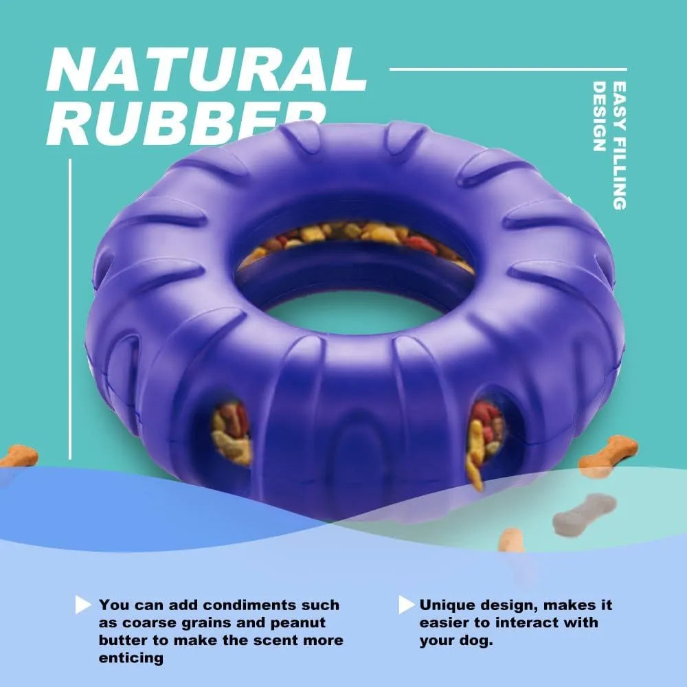 Blue natural rubber tyre-shaped dog chew toy and slow feeder with oval openings for treat dispensing.