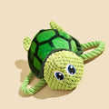 Green turtle shaped dog chewing toy with three rope knots extending from plush shell