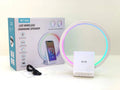 White rectangular smart device combining a wireless charging pad, Bluetooth speaker, and ambient light panel.