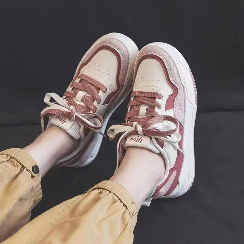 Low-top sneakers with rubber soles in beige and pink colour options showing height-increasing design