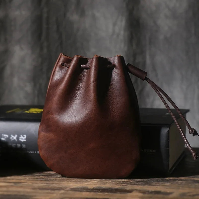 Vintage brown genuine cowhide leather drawstring bundle wallet with drawcord closed.