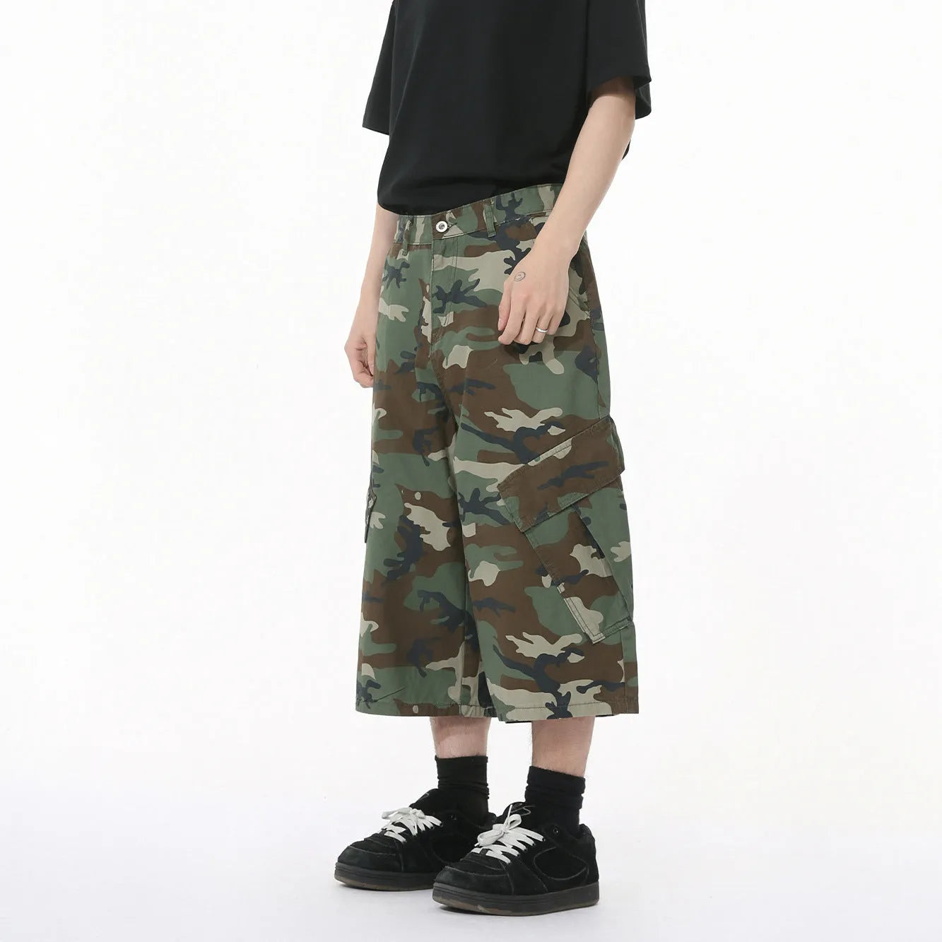 Men's loose fit camouflage cotton jeans with wide legs, cropped length, and a large side pocket.