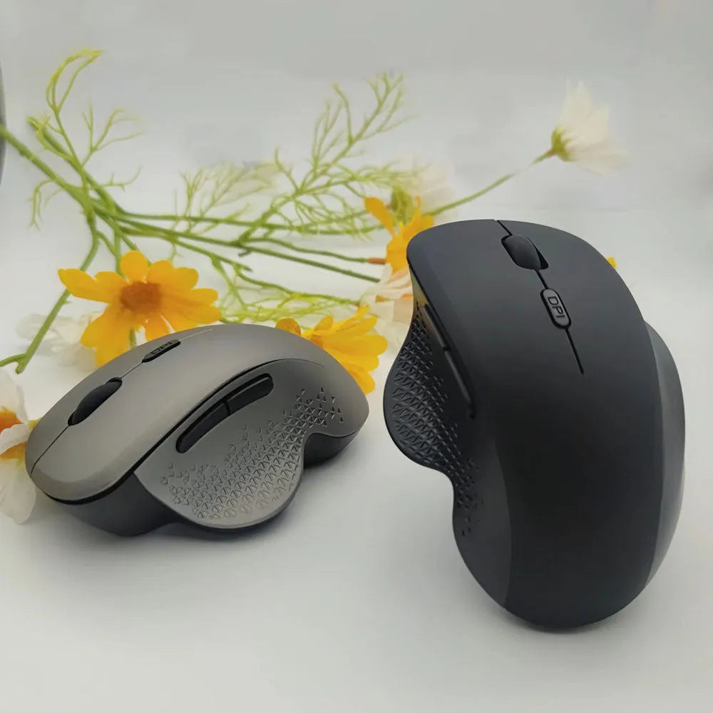 Black wireless laptop mouse with USB charging cable on grey background