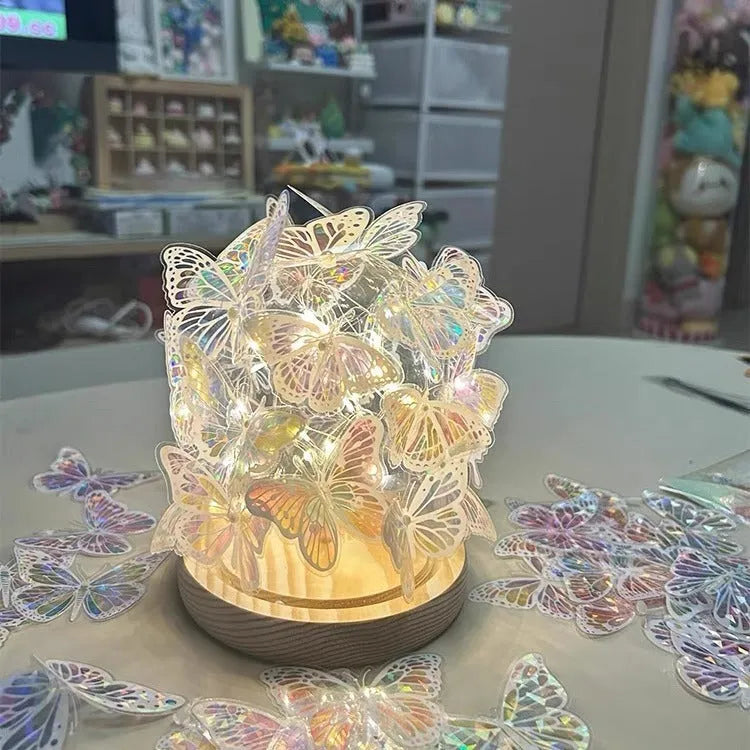 Handmade butterfly-shaped night lamp with glass shade on a raw wood base.