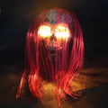 Purple plastic skeleton arm Halloween stake light illuminated in garden setting