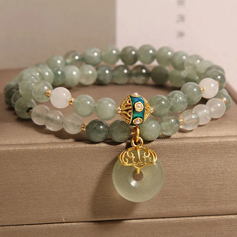 Women's double-layer aventurine jade bracelet in oil green with a safety buckle and rhinestone details.