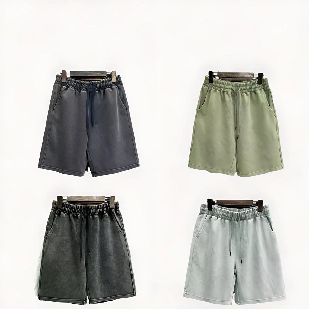 Men's distressed cotton shorts in straight-leg cut showing loose fit and solid colour options