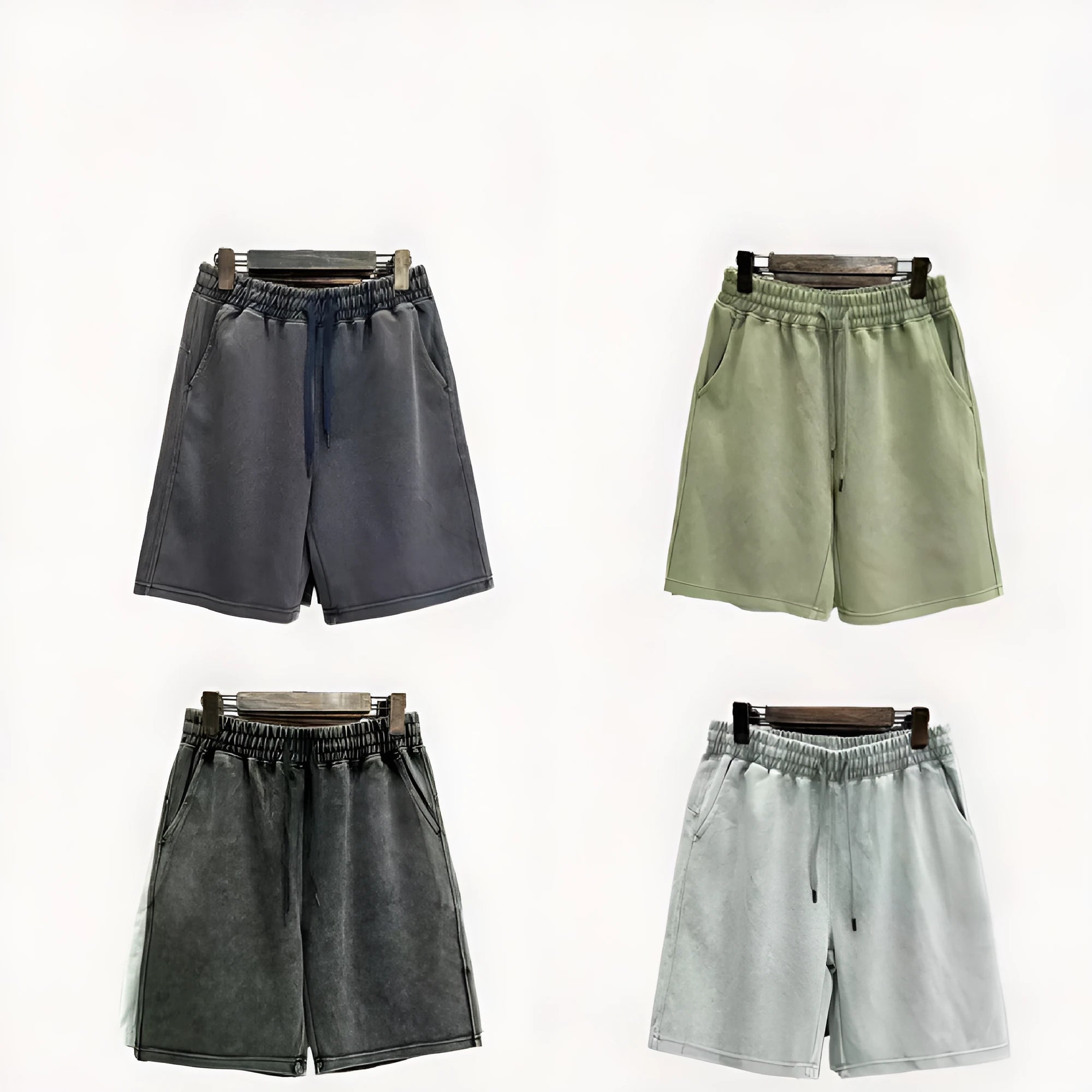Men's distressed cotton shorts in straight-leg cut showing loose fit and solid colour options