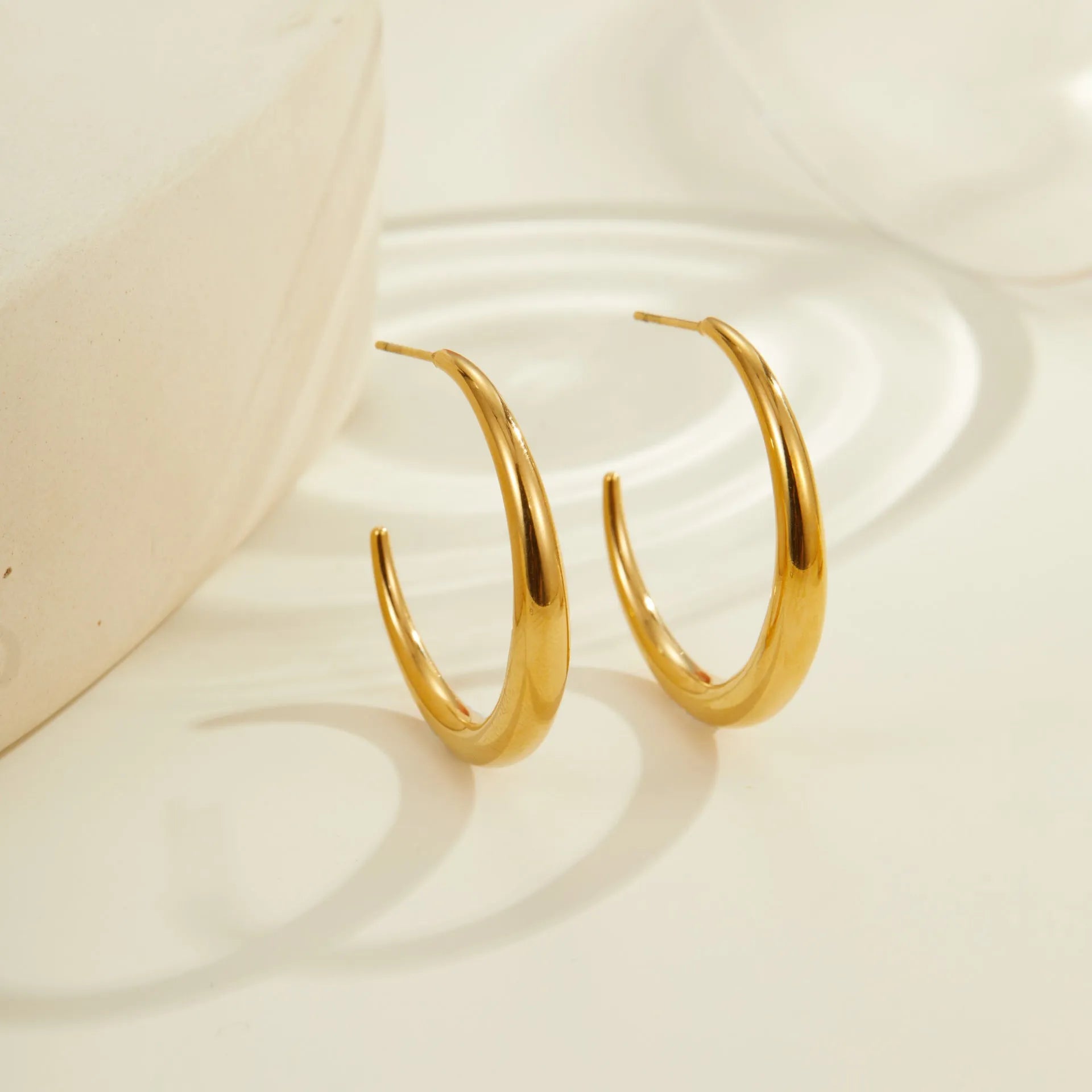 Geometric round hoop earrings in gold and steel finishes available in large and small sizes