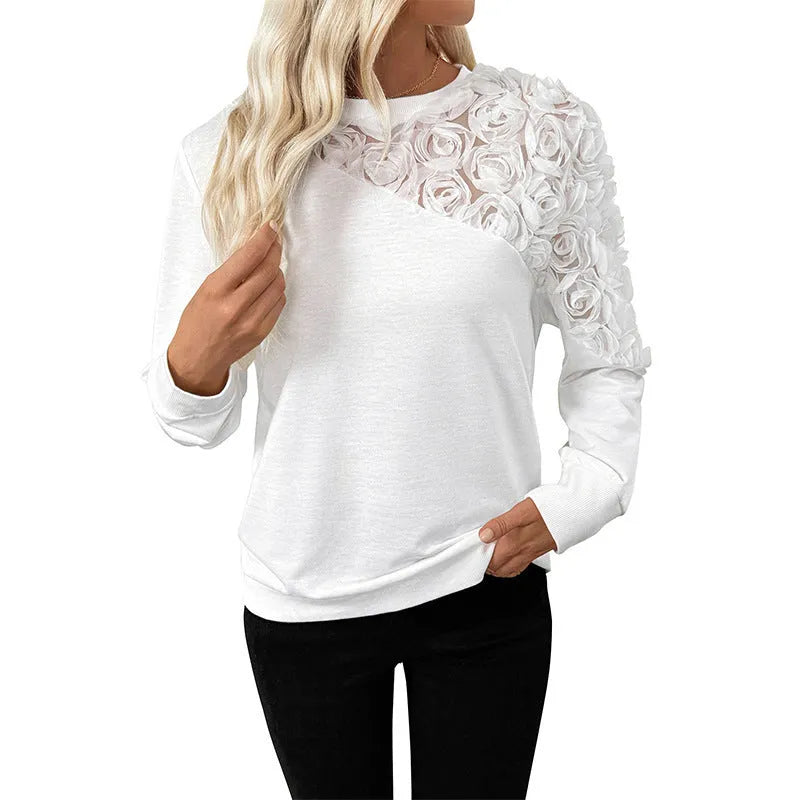 White long sleeve pullover top with a floral pattern, shown in a loose fit.