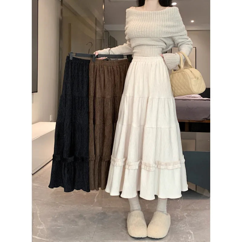 Korean style corduroy A-line midi skirt with elastic waistband in solid beige, black, or brown.