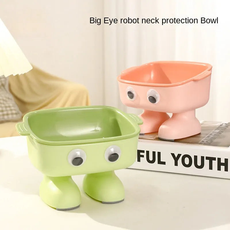 Green elevated cat bowl with 15-degree tilt, detachable inner dish, and cartoon robot design on a table.