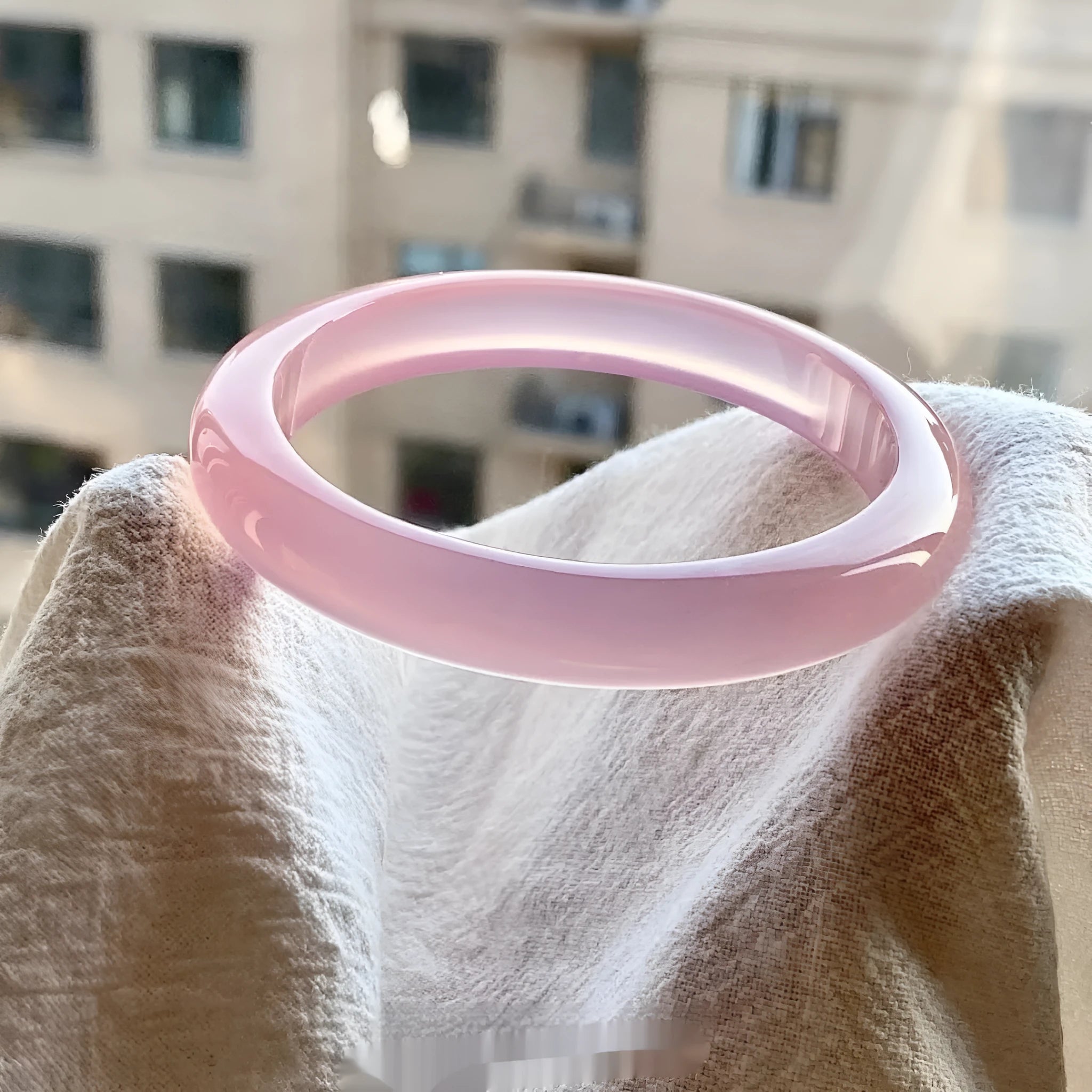 Natural agate wide tyre bracelet showing pink stone variation with size options from 52mm to 62mm