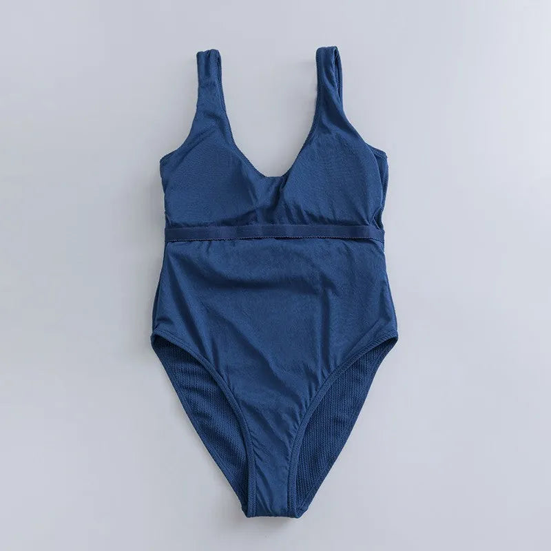 Navy blue women's one-piece swimsuit with triangle slimming design and chest pad support
