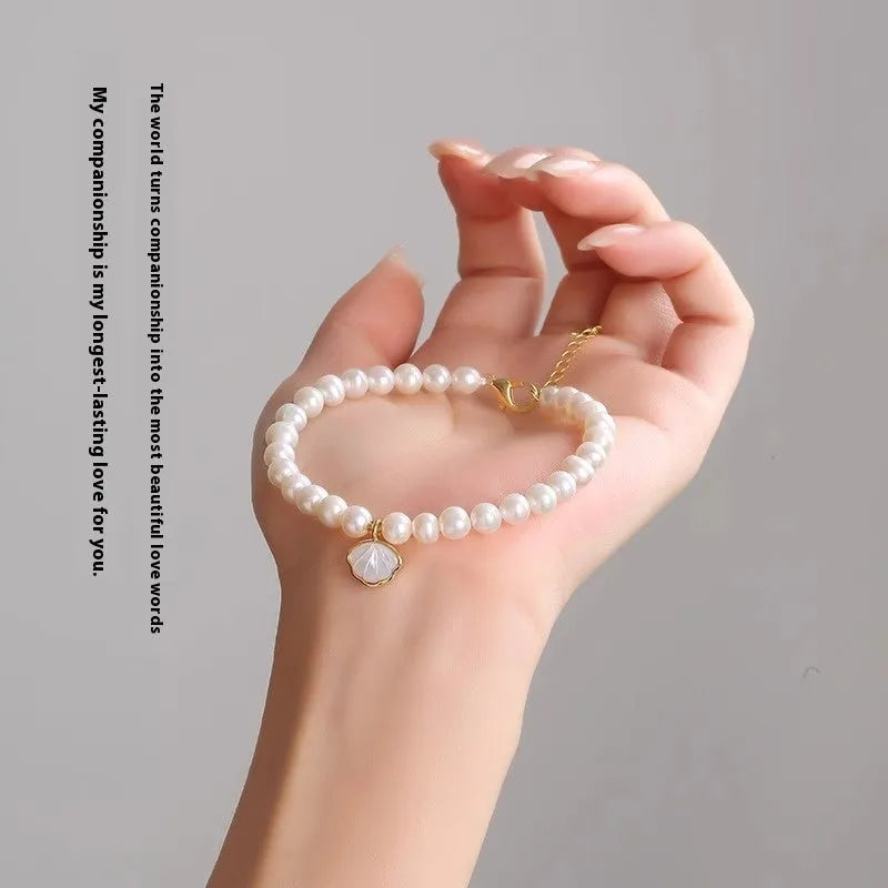 Women's freshwater pearl bracelet with fan-shaped arrangement of 5-6 near round pearls on 16cm band