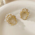Women's gold flower basket earrings with small beads and pearl inlay detailing on copper