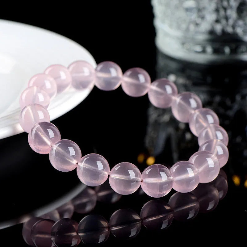 Women's natural starlight crystal bracelet with polished round pink beads in single circle configuration