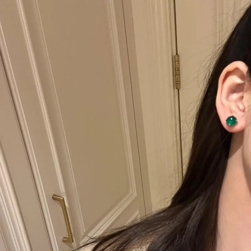 Chinese style chalcedony stud earrings with round egg surface stones in four claw settings