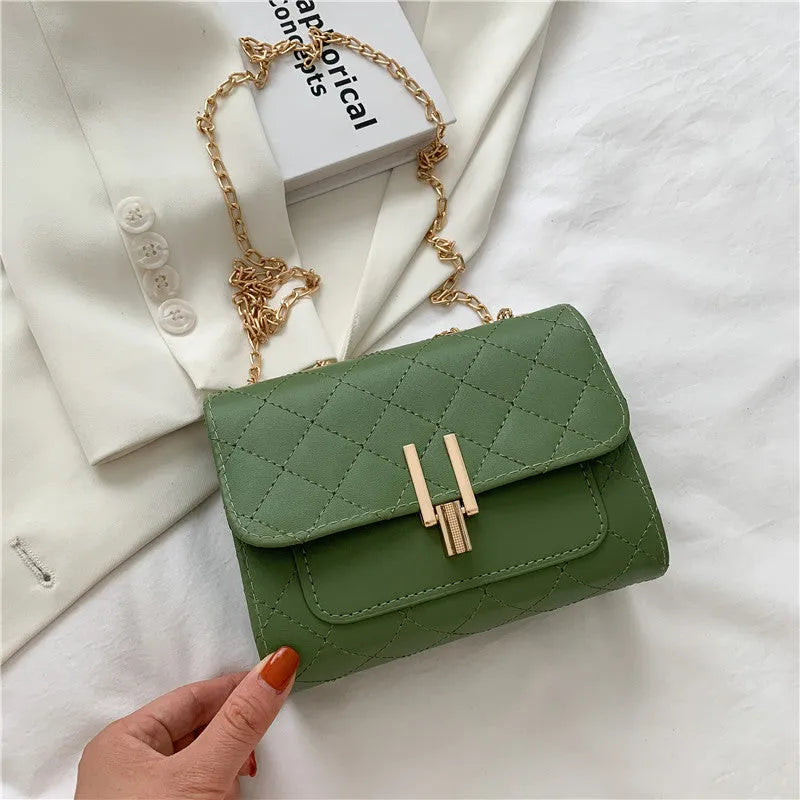 Women's minimalist crossbody bag with diamond lattice chain design in PU leather, showing adjustable strap and solid colour options