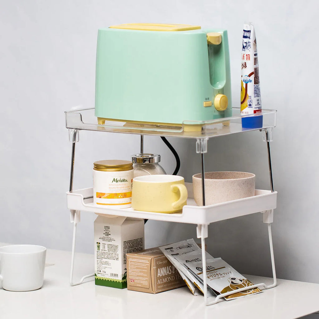 White plastic kitchen supplies rack holding bottles and jars on a countertop