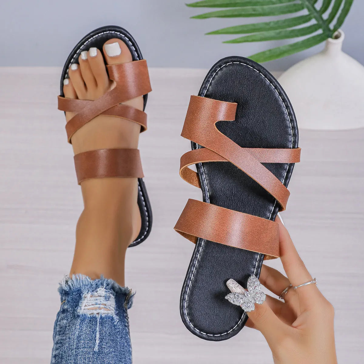 A pair of solid colour beach slippers with a round head, one-line design, and hollow-out details.