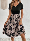 Women's khaki casual dress with plant print, A-line skirt, and shoulder strap detailing