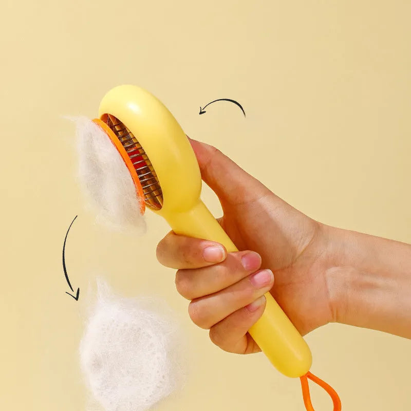 Small yellow duck-shaped pet grooming comb with open sections and needle bristles