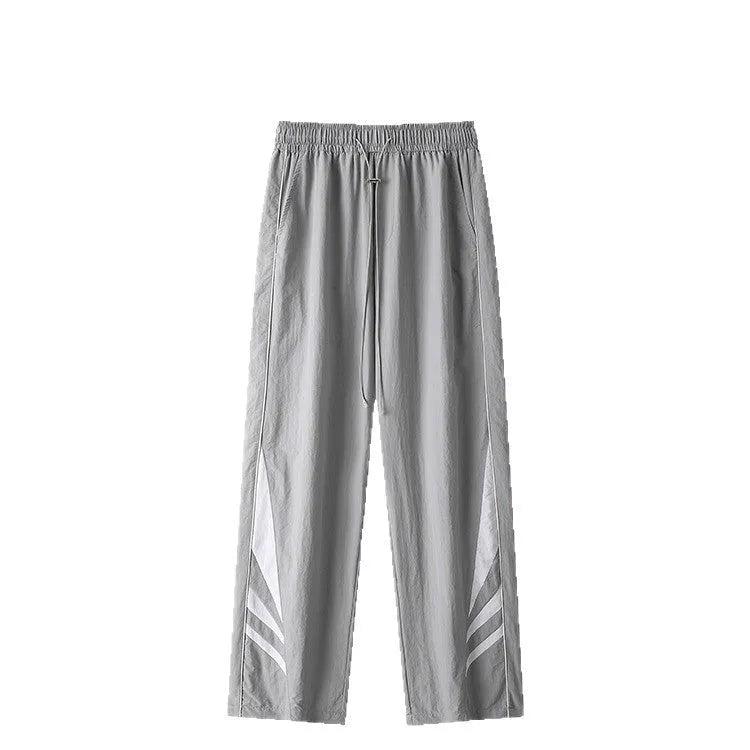 Men's straight cut loose fit casual trousers in black or grey, laid flat.