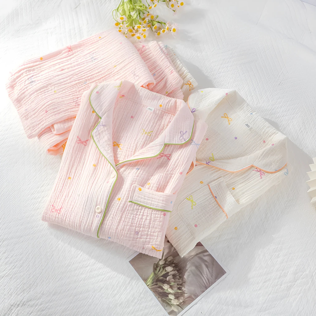Women's beige cotton crepe pajama set with long sleeves and trousers on a hanger.