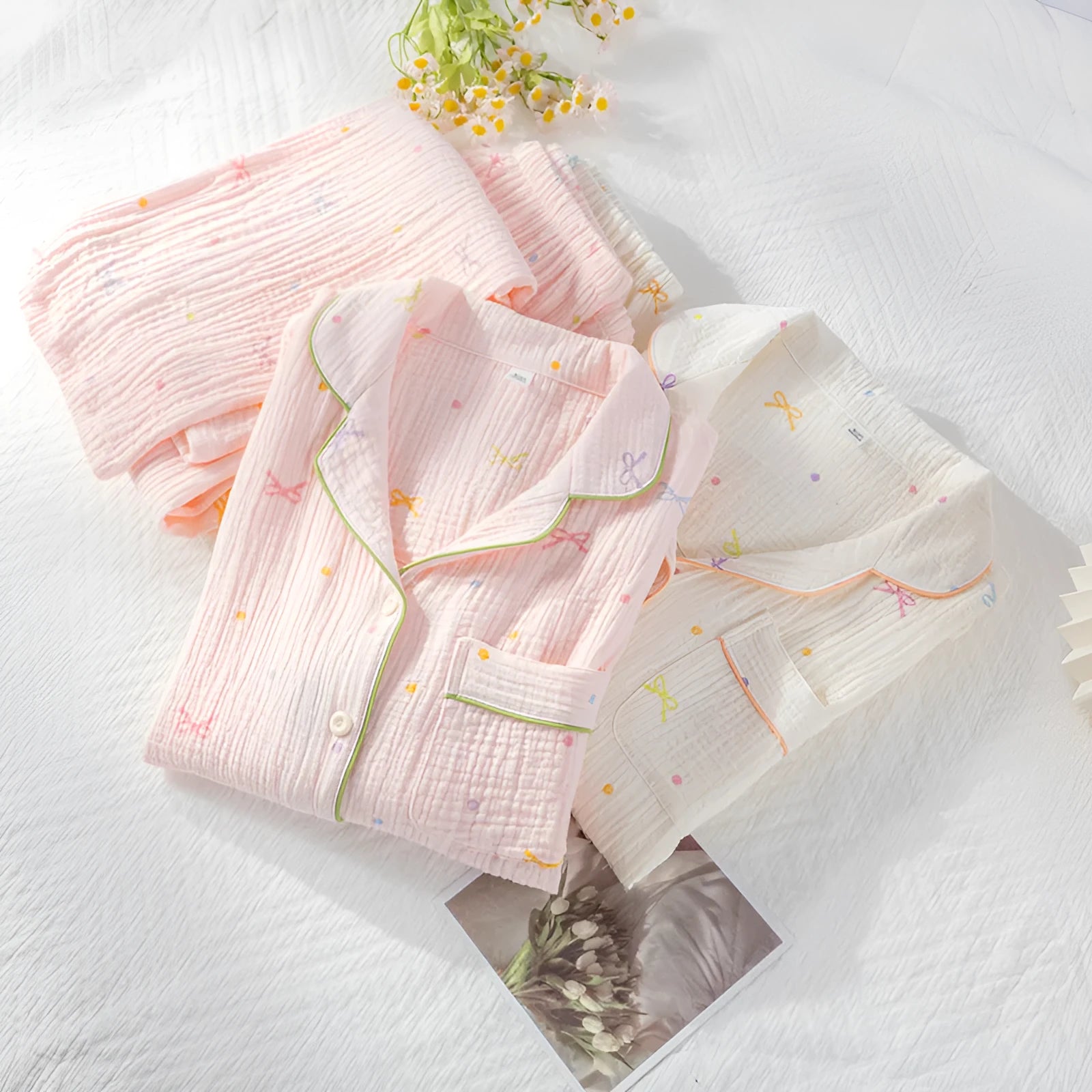 Women's beige cotton crepe pajama set with long sleeves and trousers on a hanger.
