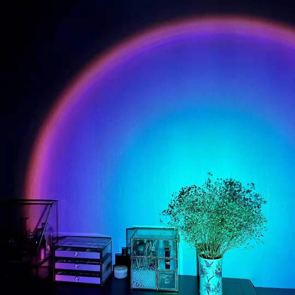 Rechargeable sunset red and rainbow projection lamp with USB cable and push-button switch.