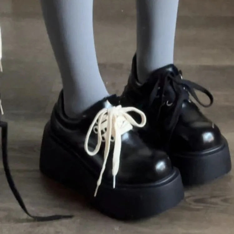 Matte black women's lace-up ankle boots with a chunky heel and thick sole.