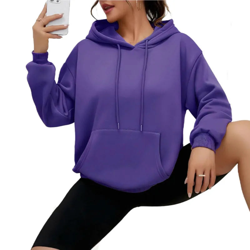 Loose grey women's sweatshirt with a drawstring waist and long sleeves on a hanger.