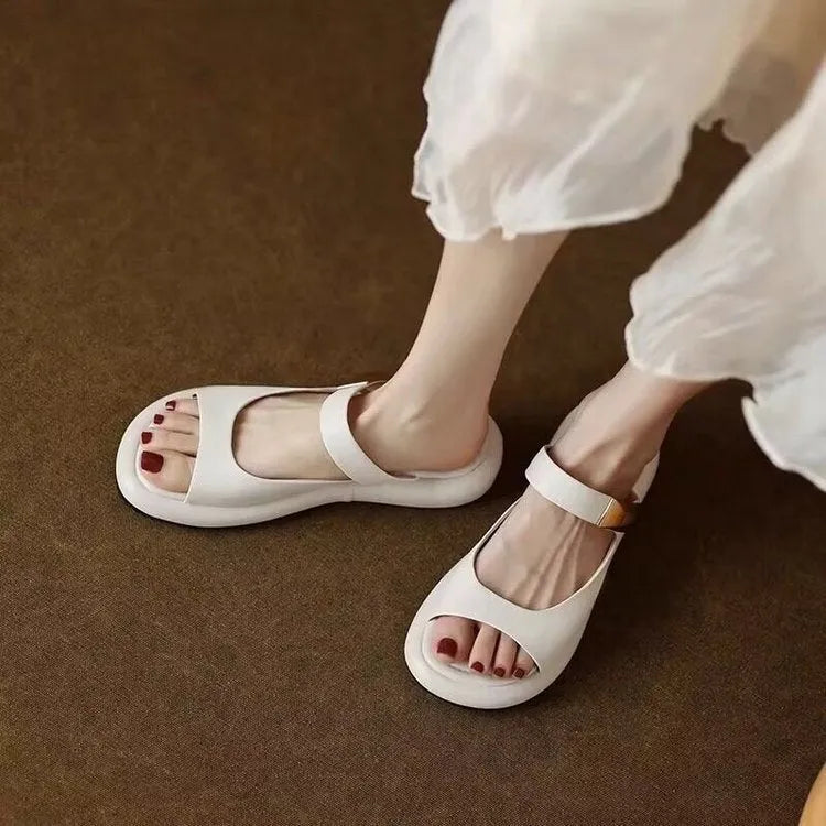 Apricot and white women's platform sandals with a peep toe and flat rubber sole.