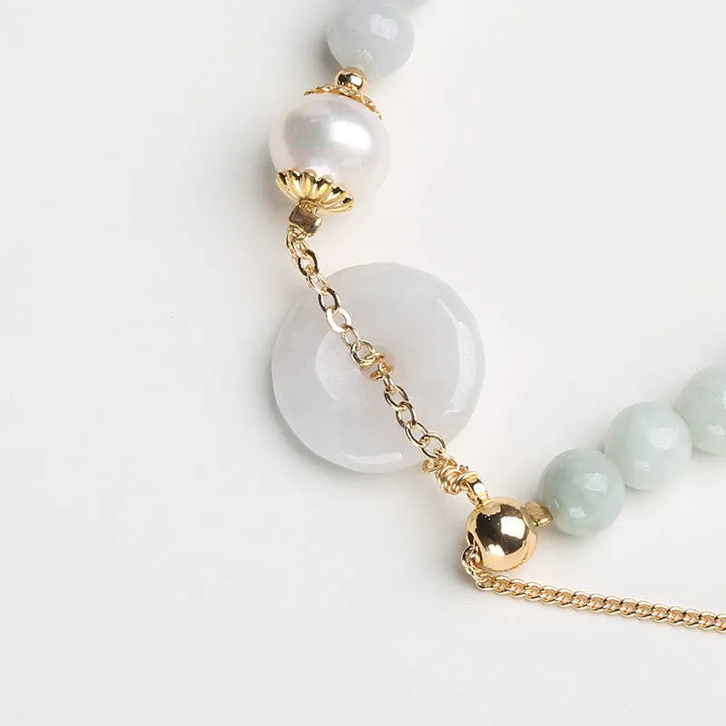 Natural emerald green jade and pearl bracelet with geometric peace buckle closure