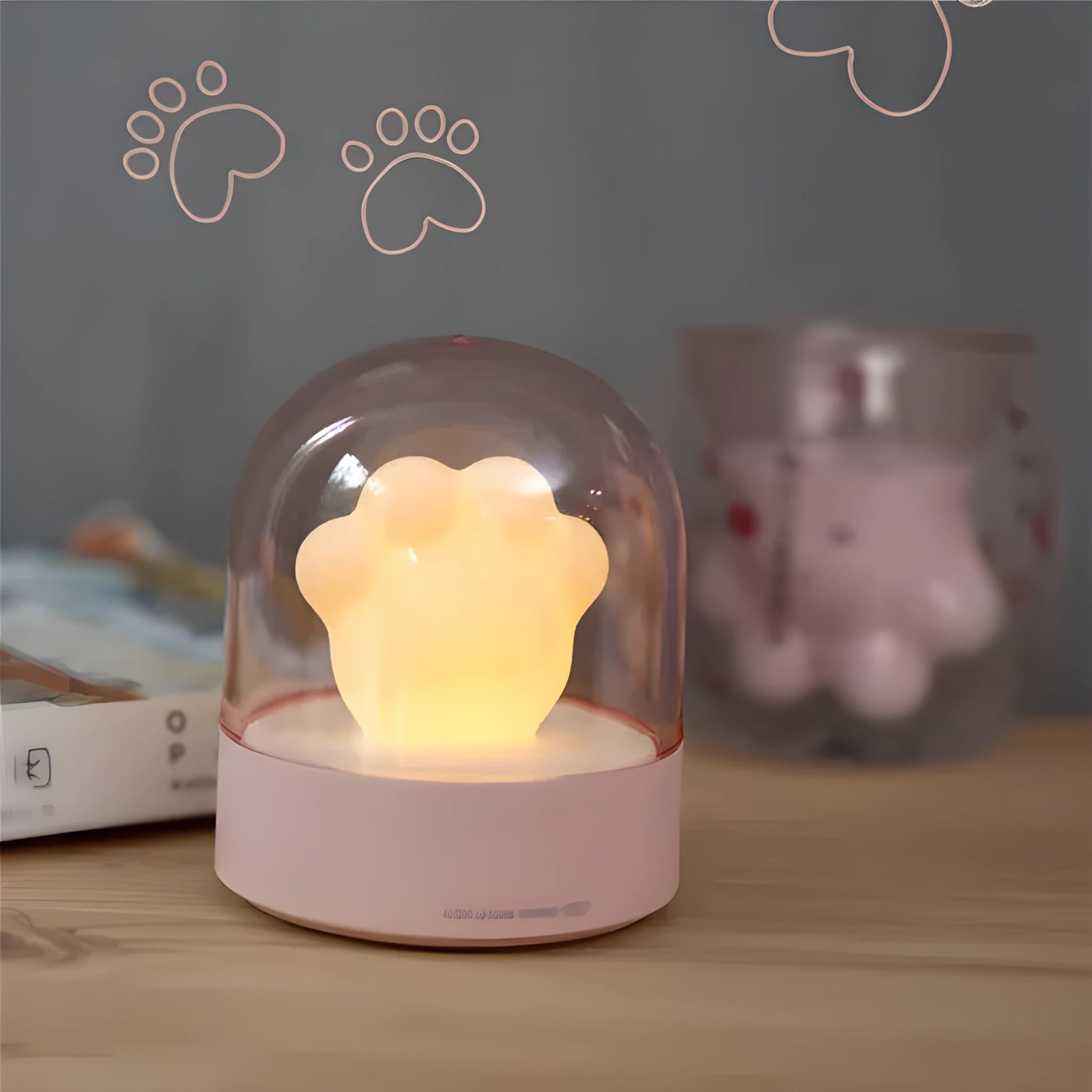 Pink cat paw shaped USB rechargeable night light with musical box function on wooden desktop