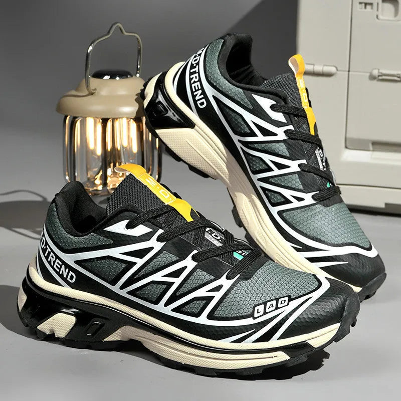 Men's and women's low-top artificial leather hiking shoes in multiple colours with flat rubber sole and lace-up front.