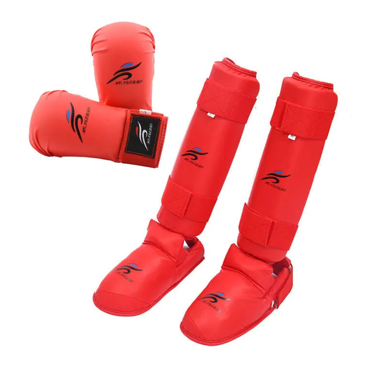 Red and blue martial arts protective gear set showing leg guards, helmet and boxing gloves for karate taekwondo training