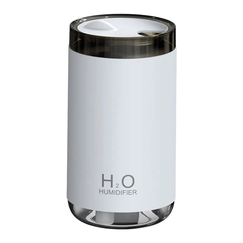 White jellyfish-themed USB humidifier with warm night light on a wooden table.
