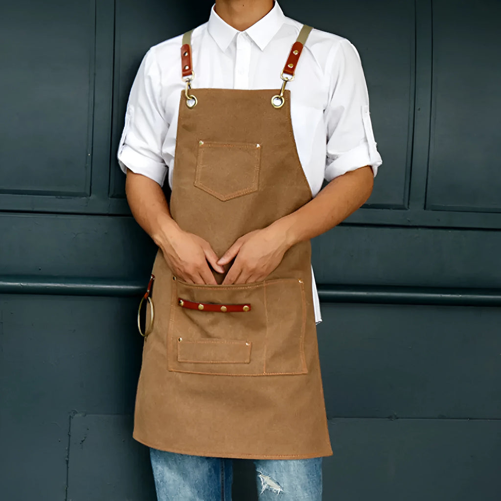 Canvas apron with cross-back straps in camel colour for kitchen and gardening protection