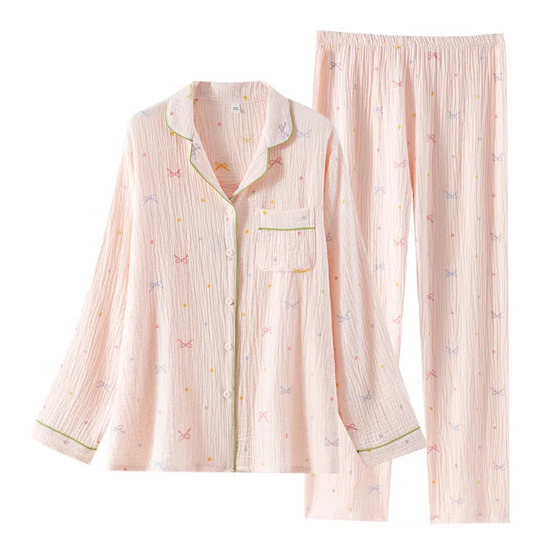 Women's beige cotton crepe pajama set with long sleeves and trousers on a hanger.