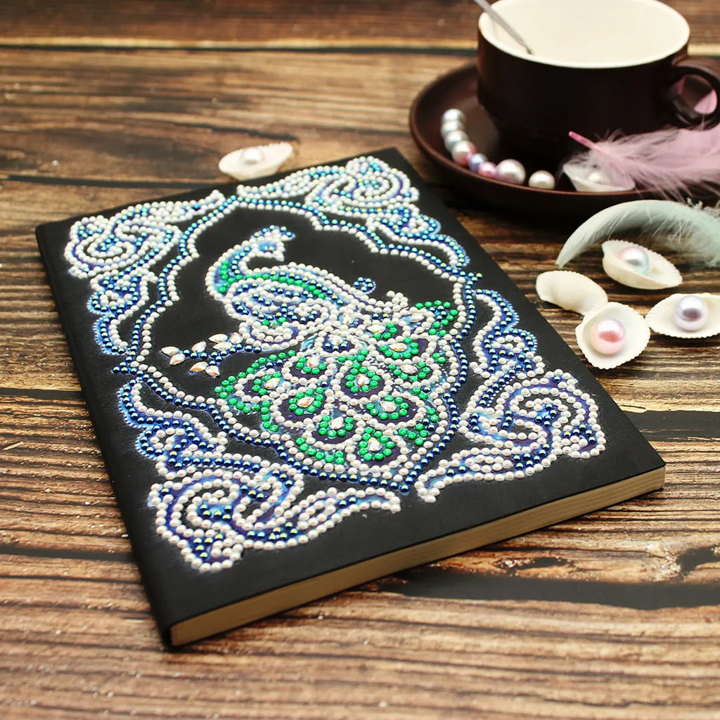 Black A5 diamond painting notebook featuring a peacock pattern with shaped and bright resin drills.