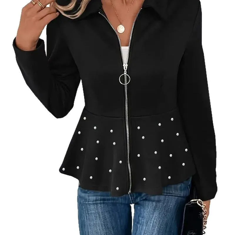 Women's black loose-fit coat with heavy-duty zipper front and ruffled hem detail.