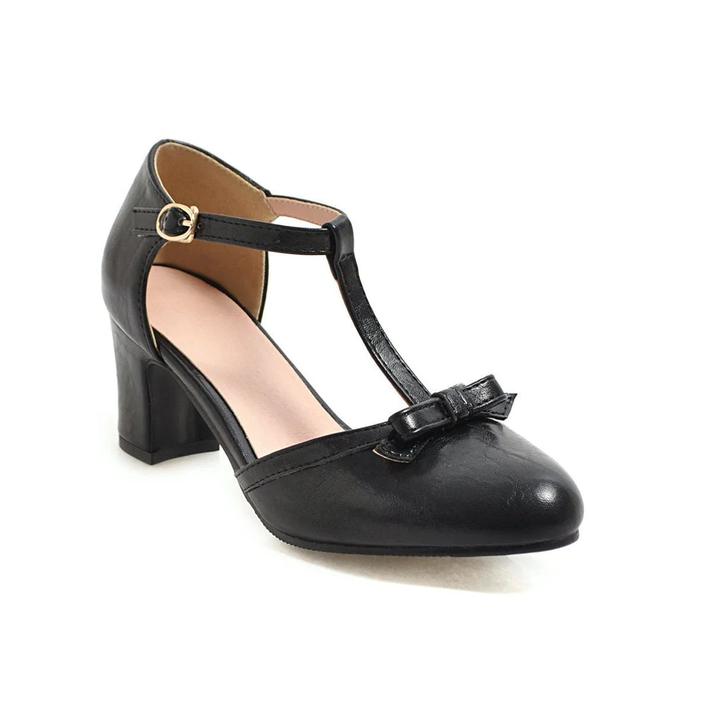 Women's solid colour sandals with chunky heel, hollow out pattern, and a bow tie on the strap.