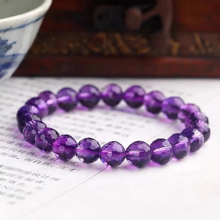 Handcrafted ametrine crystal bracelet with 128-faceted beads and a zodiac charm.
